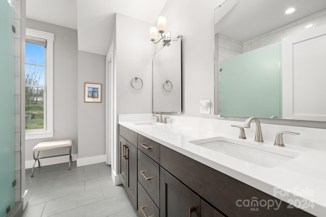 bathroom featuring vanity, tile patterned floors, and a shower with door