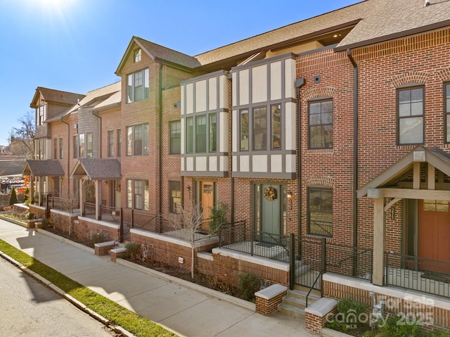 exterior space featuring brick siding and a residential view
