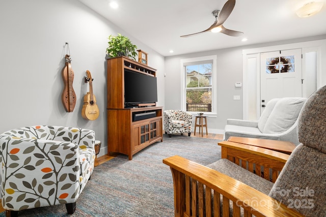 living area featuring a ceiling fan, baseboards, recessed lighting, and light wood-style floors