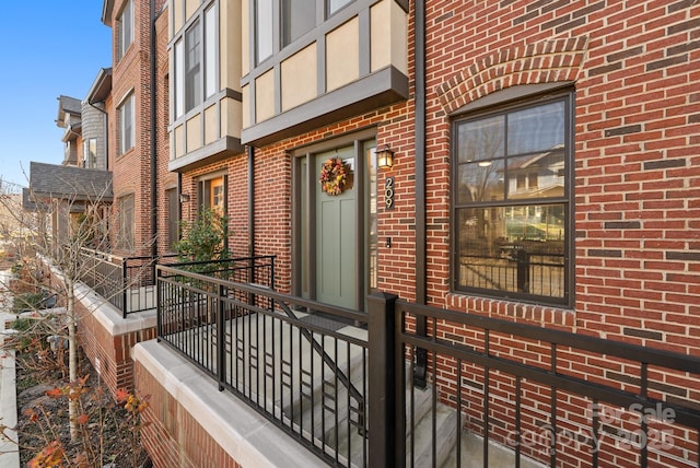 view of exterior entry with brick siding