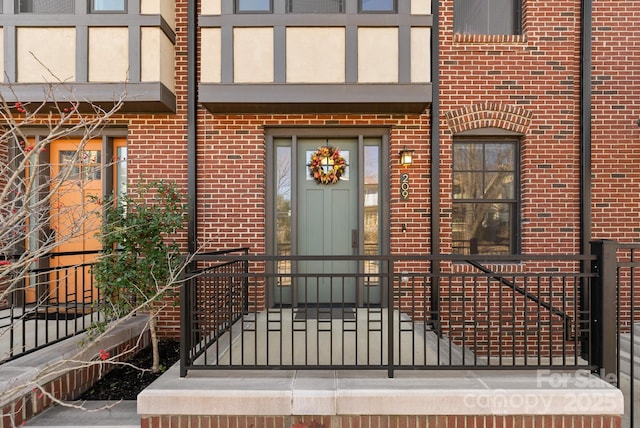 doorway to property featuring brick siding