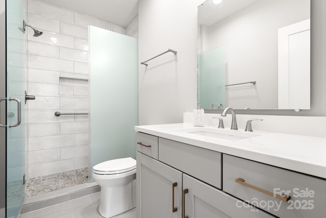 full bathroom with vanity, tile patterned floors, a shower stall, and toilet