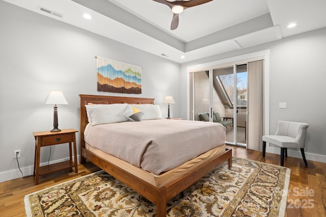 bedroom featuring access to outside, baseboards, visible vents, and wood finished floors