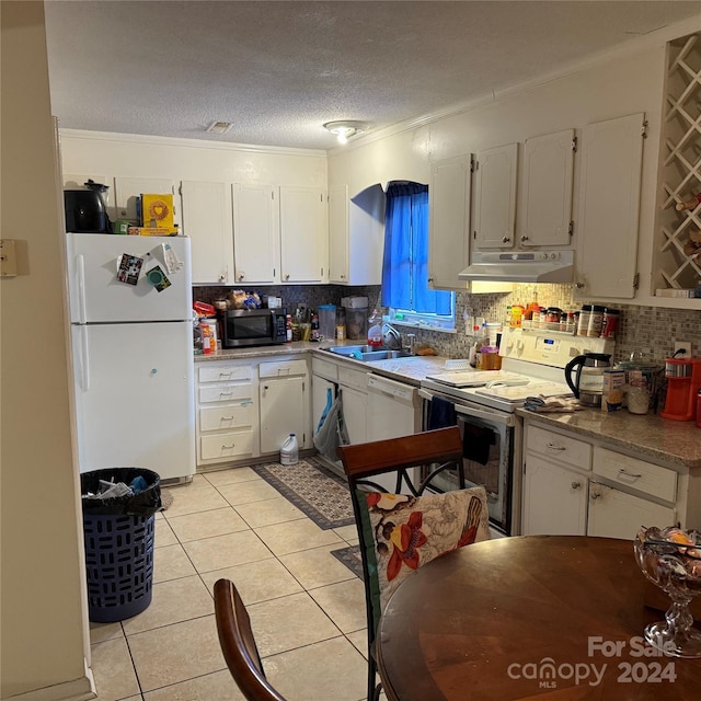 kitchen featuring white cabinetry, white appliances, crown molding, and light tile patterned floors