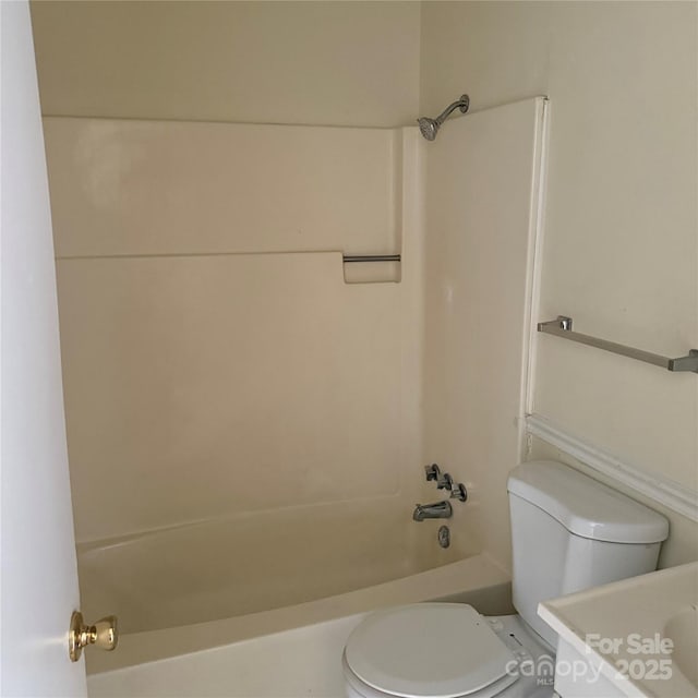 bathroom with shower / tub combination and toilet