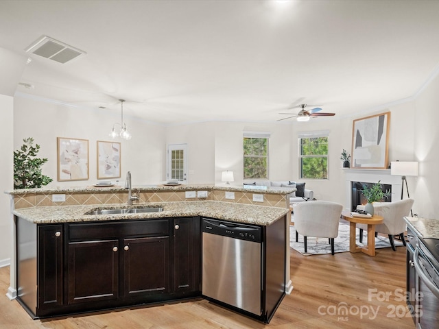 kitchen with stainless steel dishwasher, ceiling fan with notable chandelier, sink, pendant lighting, and light hardwood / wood-style flooring