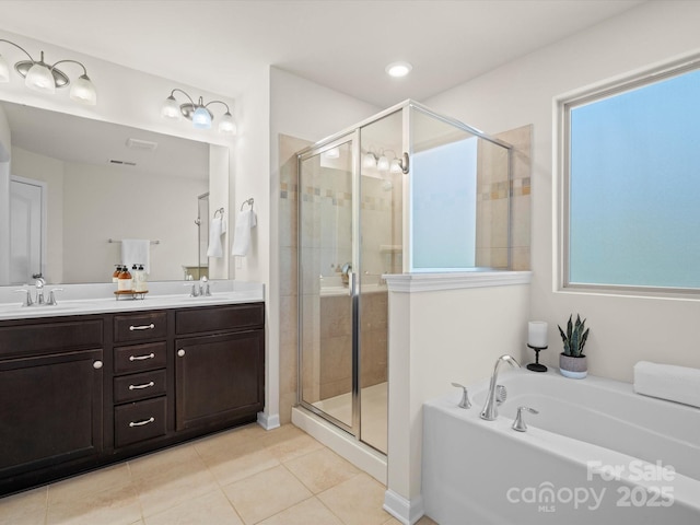 bathroom with tile patterned flooring, vanity, and independent shower and bath