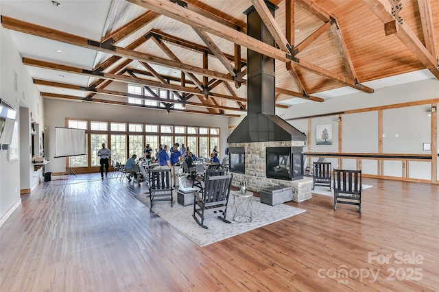 living room with beam ceiling, light hardwood / wood-style flooring, high vaulted ceiling, and wooden ceiling