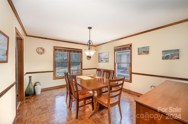 dining area with dark parquet floors and ornamental molding