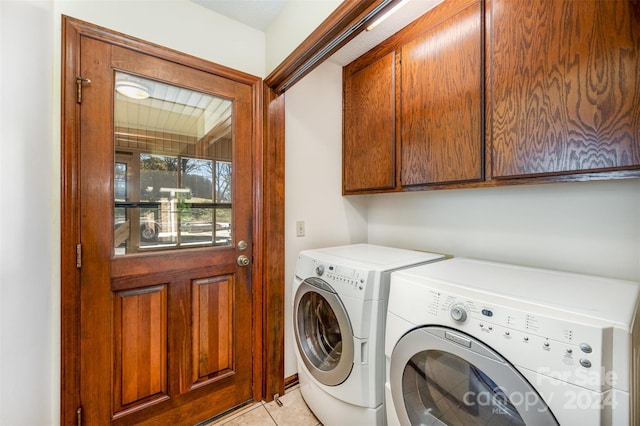 laundry room with separate washer and dryer, light tile patterned flooring, and cabinets