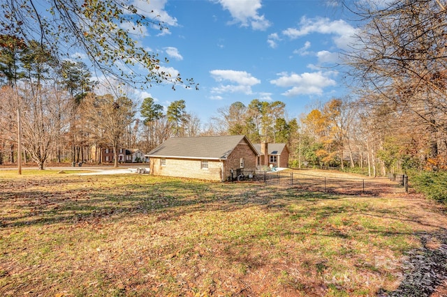 view of side of home featuring a yard