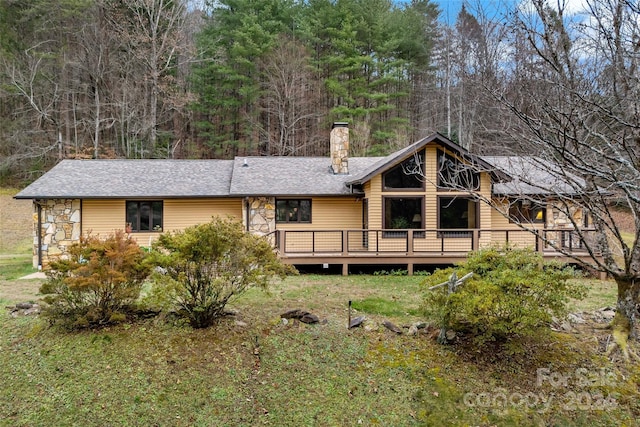 rear view of house featuring a deck