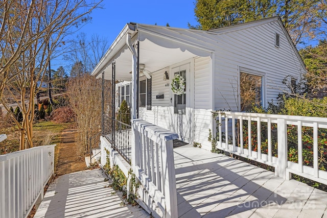 view of front of property featuring a deck and ceiling fan