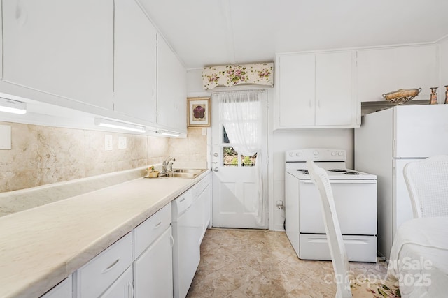 kitchen featuring white cabinetry, sink, backsplash, and white appliances