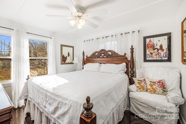 bedroom with ceiling fan and dark hardwood / wood-style floors