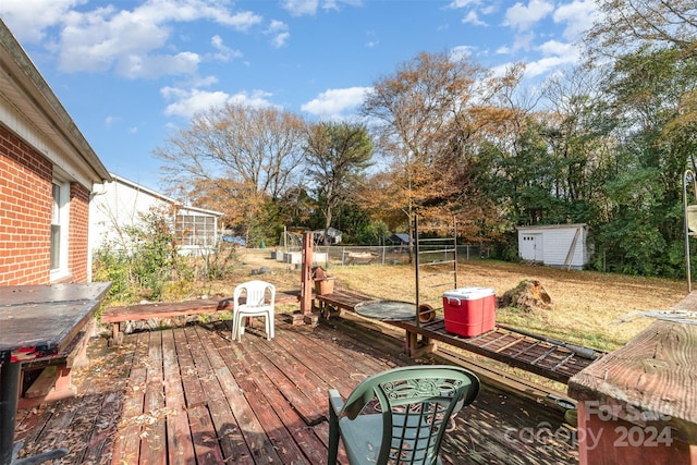 wooden deck featuring a shed