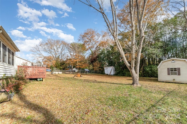 view of yard with a storage unit and a deck