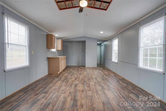 unfurnished living room with dark hardwood / wood-style floors, ceiling fan, lofted ceiling, and crown molding