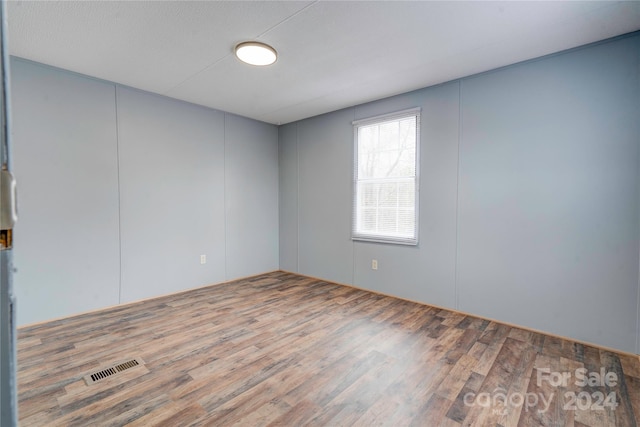 spare room with wood-type flooring