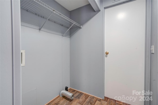 clothes washing area with hardwood / wood-style floors