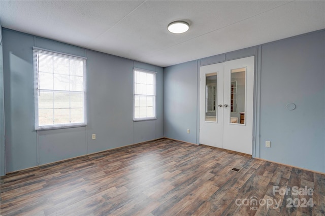 2124 Mcbrayer Springs Rd, Shelby, NC 28150 - empty room with wood finished floors, french doors, and a textured ceiling