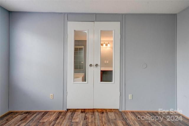 unfurnished room featuring french doors and hardwood / wood-style flooring