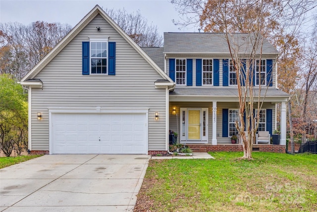 view of front of property with a porch, a garage, and a front lawn