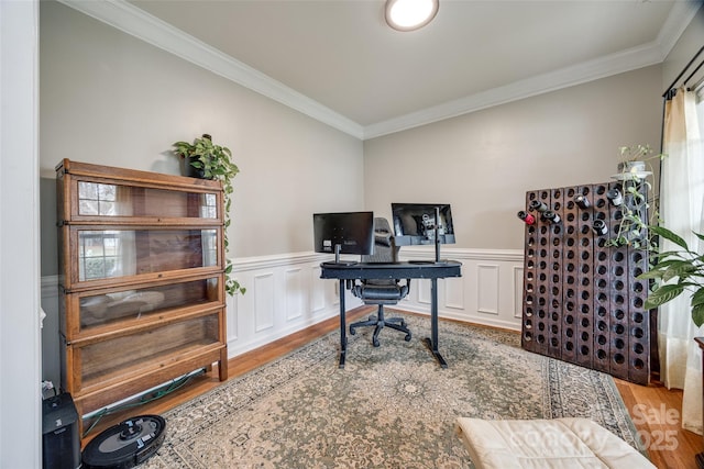 office area with light hardwood / wood-style floors and crown molding