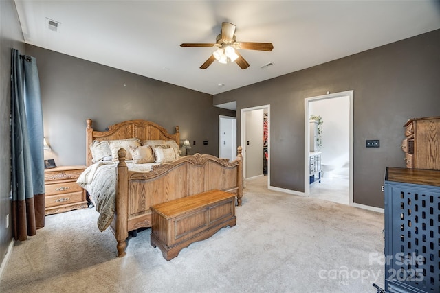 carpeted bedroom with a walk in closet, ceiling fan, a closet, and ensuite bathroom