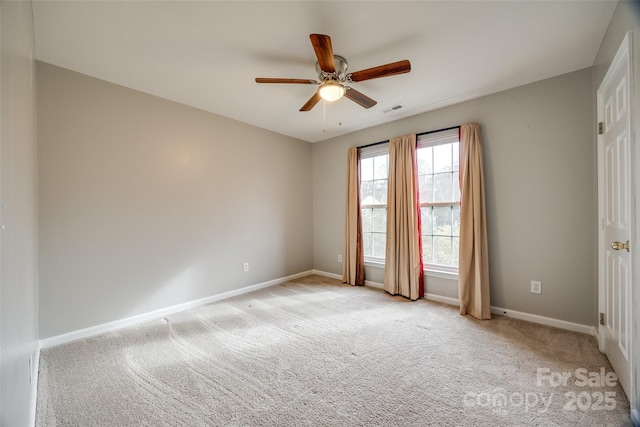 empty room with light colored carpet and ceiling fan