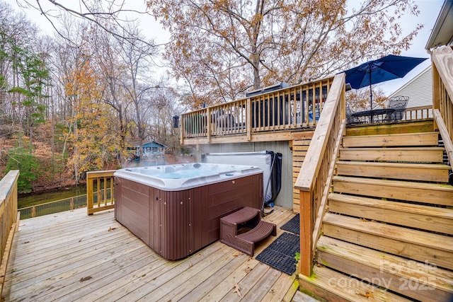 wooden terrace featuring a hot tub