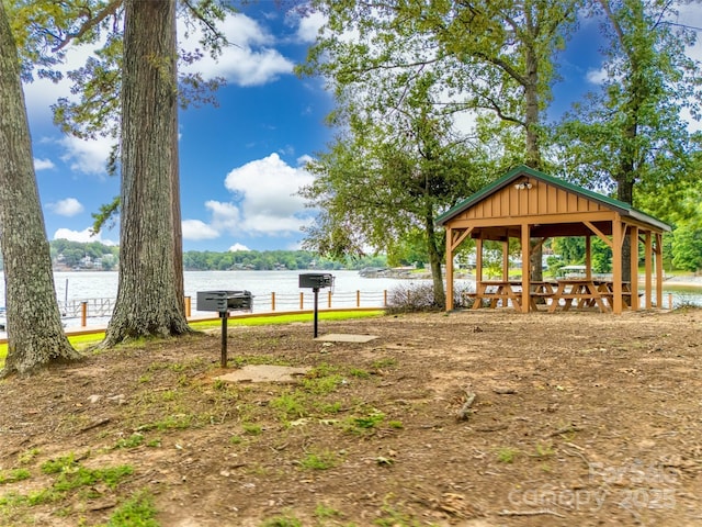 view of yard featuring a gazebo and a water view