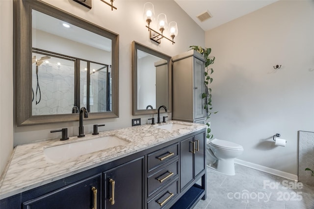 bathroom featuring vanity, a shower with shower door, and toilet