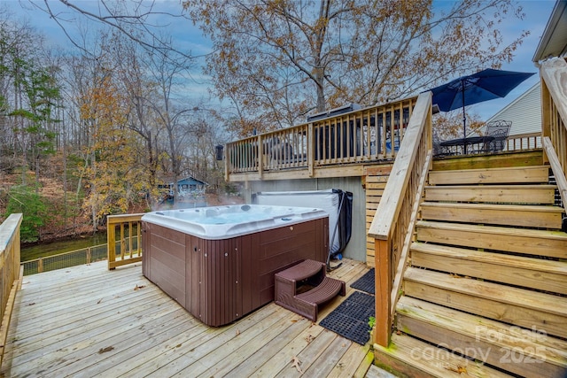 wooden terrace featuring a hot tub