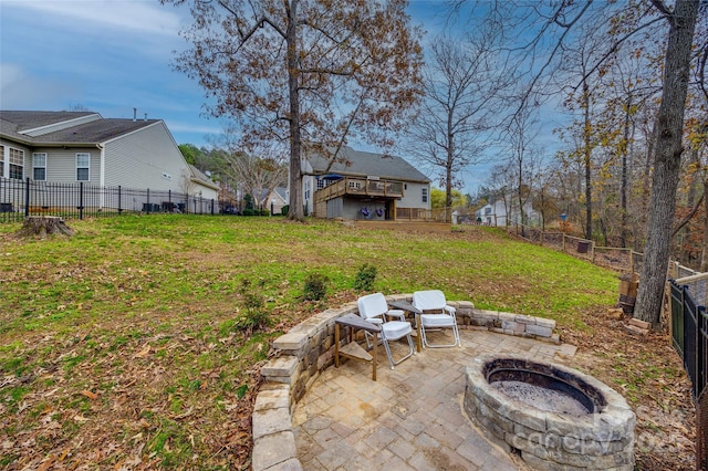 view of yard featuring a patio area, a deck, and an outdoor fire pit