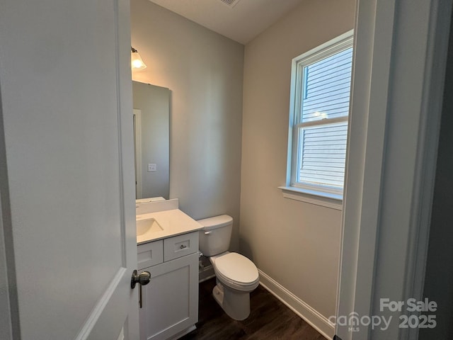 bathroom with vanity, hardwood / wood-style flooring, and toilet