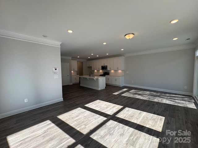 unfurnished living room with dark hardwood / wood-style flooring, ornamental molding, and sink