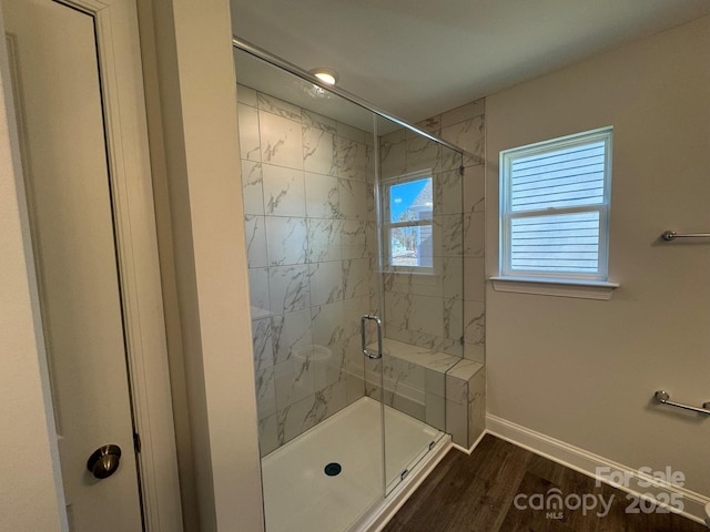 bathroom with hardwood / wood-style floors and walk in shower