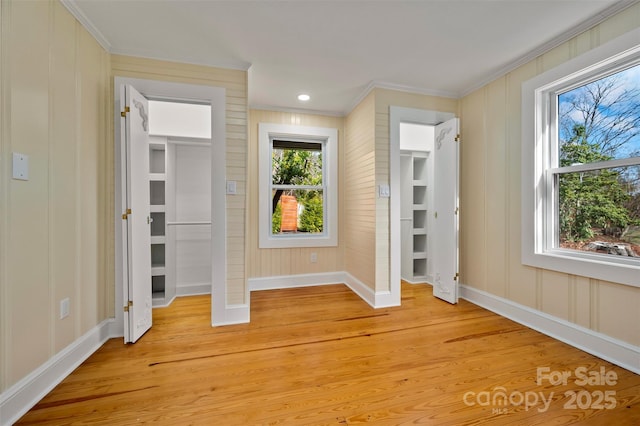 unfurnished bedroom with crown molding and light hardwood / wood-style flooring