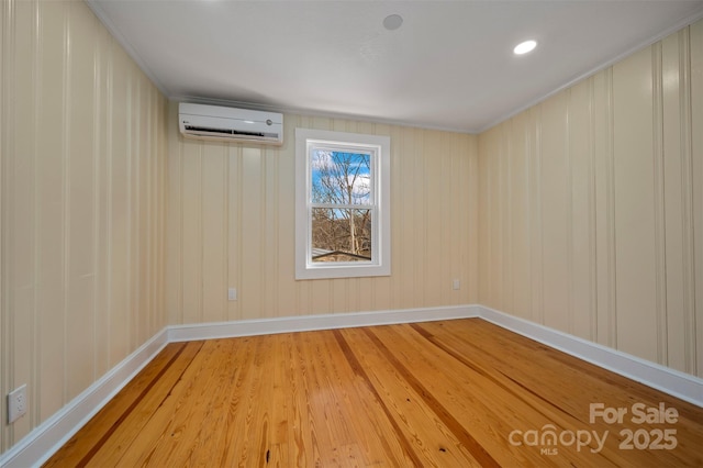 empty room with hardwood / wood-style floors and a wall unit AC