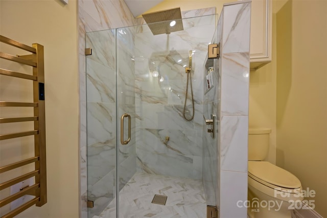 bathroom featuring toilet and an enclosed shower