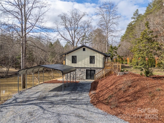 view of front of house featuring a carport and a water view