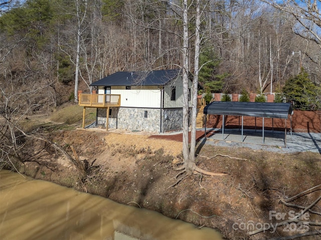 rear view of house featuring a carport