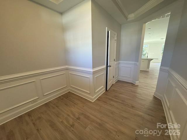 hallway featuring hardwood / wood-style floors and ornamental molding