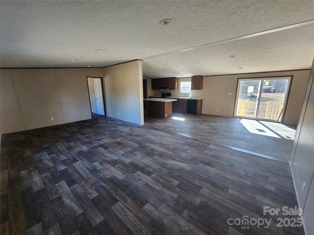 unfurnished living room with dark hardwood / wood-style floors and a textured ceiling