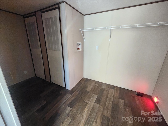 clothes washing area with dark hardwood / wood-style flooring and hookup for a washing machine