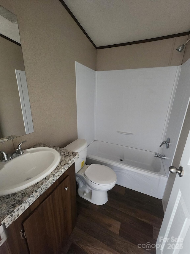 full bathroom featuring toilet, wood-type flooring, shower / washtub combination, and vanity