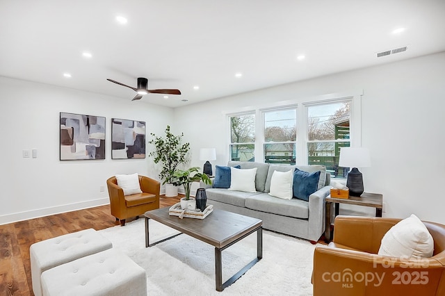 living room with hardwood / wood-style floors and ceiling fan