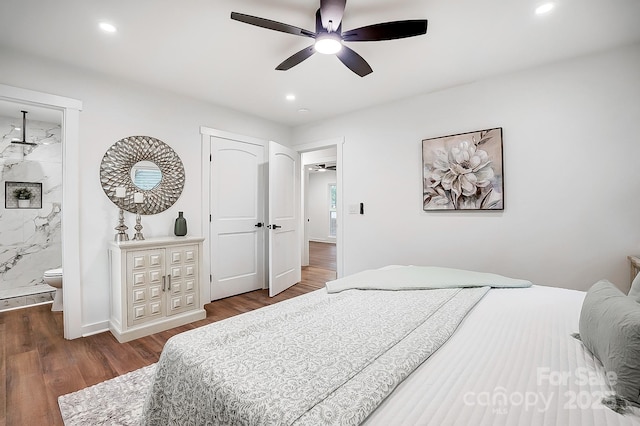 bedroom with hardwood / wood-style flooring, ceiling fan, and connected bathroom