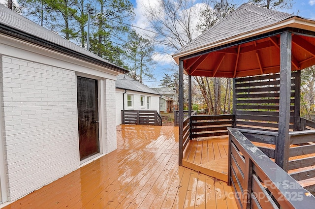 wooden terrace featuring a gazebo